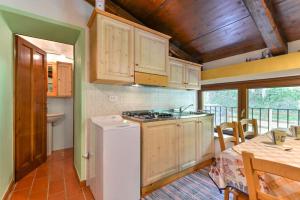 a kitchen with a refrigerator and a stove top oven at 38-Volpini House In Amiata - Val d'Orcia, Saturnia, Feste&Sagre in Castel del Piano +73 photos