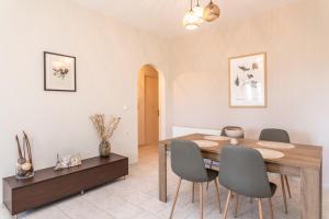 a dining room with a wooden table and chairs at Emily Apartment in Zakynthos Town