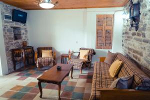 sala de estar con sofás, sillas y mesa en Guest House Edmond, en Gjirokastra