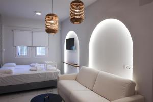 a living room with a couch and a bed at Uphill Unique Boutique Suites in Skiathos