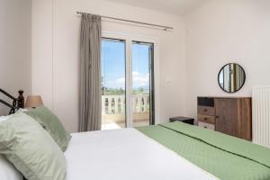 a bedroom with a bed and a large window at Emily Apartment in Zakynthos Town