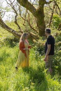 a man and a woman standing in a field at The Common Knowledge Centre in Kilfenora