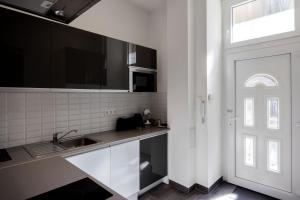 a kitchen with a sink and a white door at Elegant Studio in Central Budapest in Budapest
