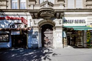 a building with an archway in the middle of a street at Elegant Studio in Central Budapest in Budapest