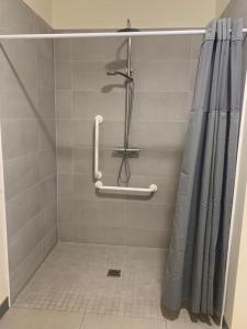 a shower in a bathroom with a shower curtain at Ard Locha - Lake View Apartment 