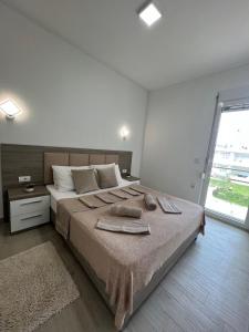 a bedroom with a large bed with towels on it at Rasi Luxury Apartments in Ulcinj