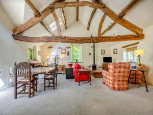 a kitchen and living room with wooden beams at Mill Barn in Askham