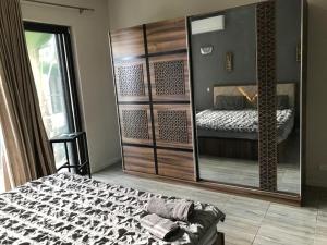 a bedroom with a bed and a large mirror at Flic en flac Mauritius in Flic-en-Flac