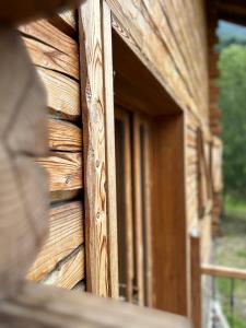 een houten deur van een blokhut met een raam bij LA PIANA DAL SAS in Gravellona Toce