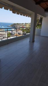 an empty balcony with a view of the ocean at Kerasies Studios in Patitiri