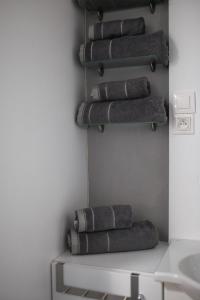 a stack of gray towels hanging on a wall at Apartman Lastovicka in Stará Lesná