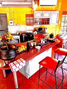a kitchen with a red counter top in a room at Kruger River View in Marloth Park