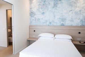 Postel nebo postele na pokoji v ubytování Hotel Cristallo