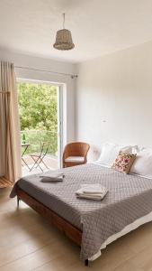 a bedroom with a large bed and a window at ELÉA Guesthouse himare in Himare +37 photos