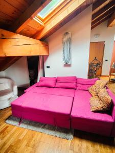 - un grand canapé rose dans le salon dans l'établissement Mountain View Hideaway, à Ballabio