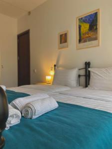 Mood Hotel Kazbegi في كازباجي: غرفة نوم عليها سرير وفوط