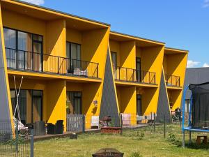 een geel appartementencomplex met een geel bij A stylish & cozy terraced house in Tartu in Tartu