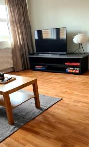 a living room with a tv and a coffee table at Lovely one bedroom apartment in Hafnarfjordur in Hafnarfjördur