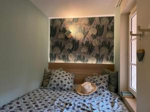 a bedroom with a bed with a hat on it at Cap Estérel Rivièra Studio in Saint-Raphaël