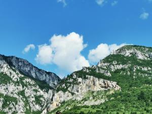 a group of mountains with a blue sky and clouds at Apartament 14 in Băile Herculane +3 photos