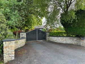 a gate in a stone wall with a driveway at Apartment - Clonlyne House in Oldcastle