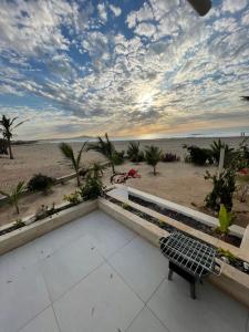 a bench on a patio with a view of the beach at Villa Alfredo Marchetti Nº13 A Suites on the Beach, Praia de Chaves, Boa Vista in Cabeçadas