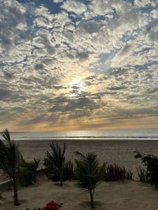 una playa con palmeras y un cielo nublado en Villa Alfredo Marchetti Nº13 A Suites on the Beach, Praia de Chaves, Boa Vista en Cabeçadas