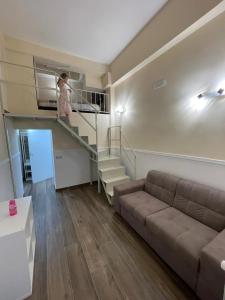 a girl standing on a staircase in a living room at B&B Fuorigrotta in Naples