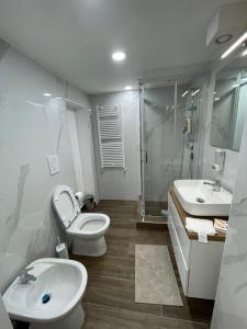 a bathroom with a toilet and a sink and a shower at B&B Fuorigrotta in Naples
