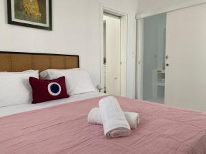 a bedroom with a bed with a pillow with an eye on it at Octopus Suites Parikia in Parikia
