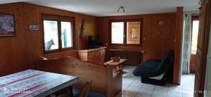 a living room with a table and a chair at Le Randonneur in Flumet