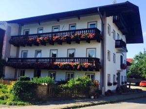 a white building with flowers on the side of it at STAYBEST Apartment König Ludwig in Prien am Chiemsee