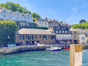 a group of buildings and boats in a body of water at Keepers Cottage in Helland