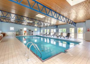 a large swimming pool in a large building at Brixham Holiday Park in Brixham