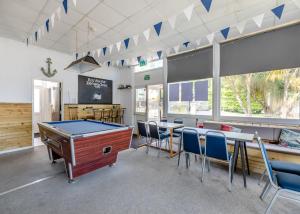 a billiard room with a pool table and chairs at Brixham Holiday Park in Brixham +62 photos