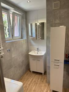 a bathroom with a white sink and a mirror at Apartamenty Oaza Spokoju in Sopot +63 photos