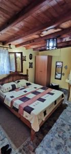 a bedroom with a large bed in a room at Koliba Oaza mira in Lopatnica