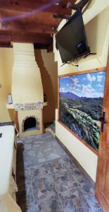 a room with a tv and a large window at Koliba Oaza mira in Lopatnica