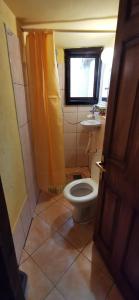 a small bathroom with a toilet and a sink at Koliba Oaza mira in Lopatnica