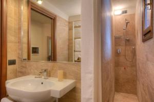 a bathroom with a sink and a shower at Locanda La Brenva - Estella Hotel Collection in Courmayeur