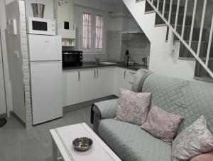 a living room with a couch and a kitchen at La Casita de Ubrique in Ubrique