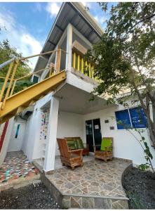 a house with two chairs and a staircase at Apartamentos Katy in San Andrés