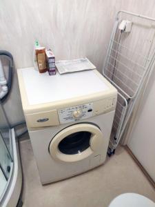 a washing machine in a bathroom with a toilet at The Private Quarters in Vårsta