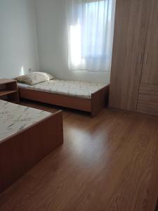 a room with two beds and a window at Apartman Car in Vir
