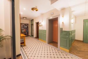 a hallway with green cabinets and a tile floor at H Villa Herkules in Świnoujście