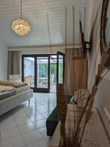 a living room with a couch and a chandelier at Garden View Apartment in Breitenbrunn