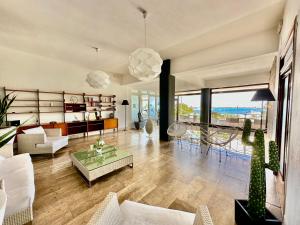 a living room with a view of the ocean at Abitare in Vacanza in La Caletta