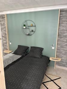 a bedroom with a bed with a mirror on the wall at Coconning studio in Plauzat