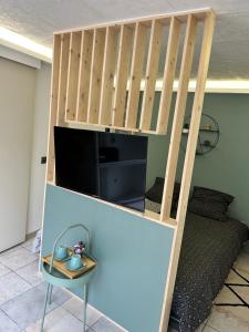 a loft bed in a room with a desk and a chair at Coconning studio in Plauzat