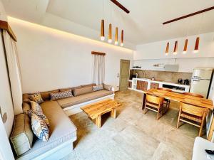 a living room with a couch and a table at Aeris suites Pori in Koufonisia